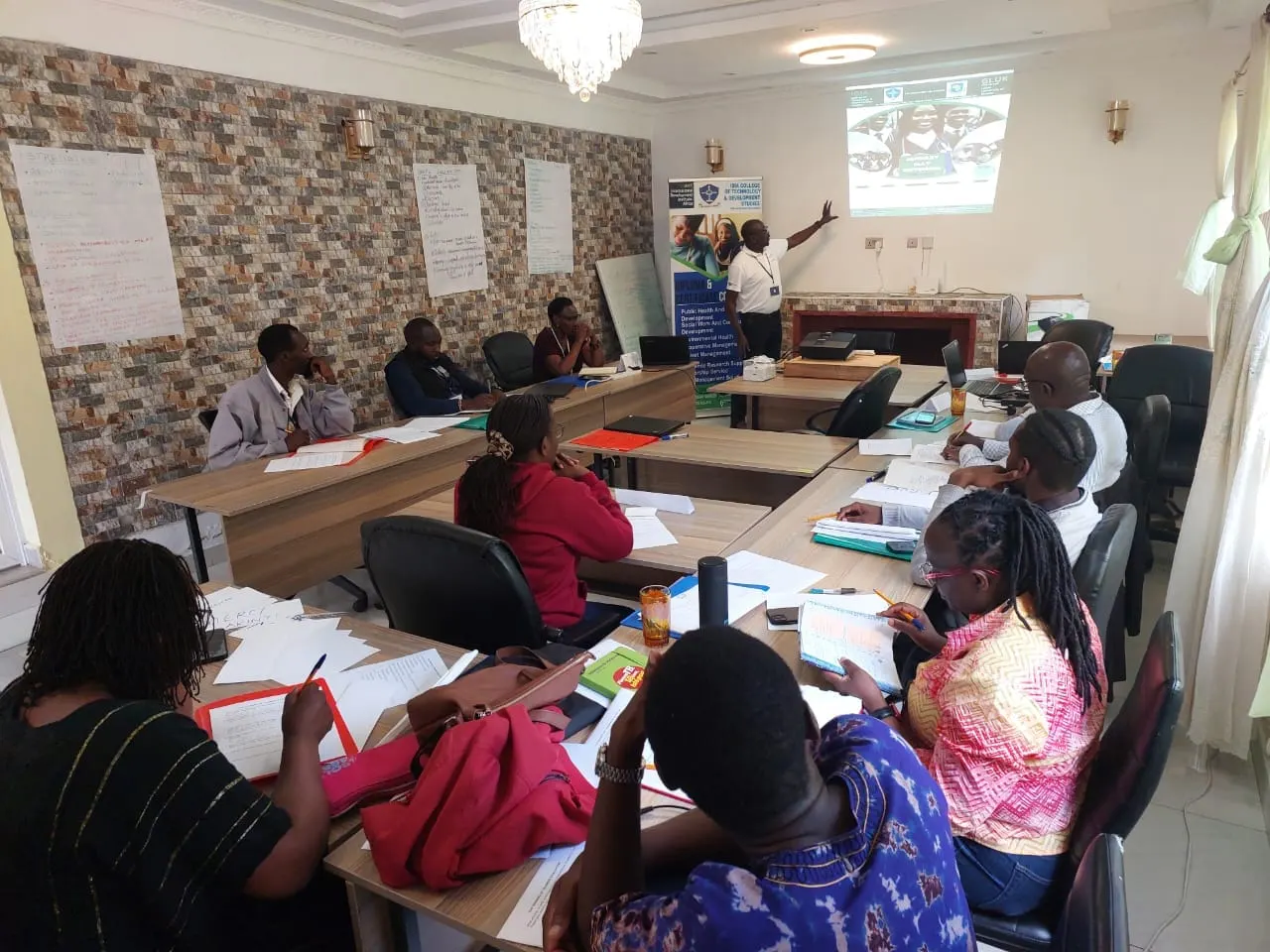 Students following a presentation in an IDIA College classroom