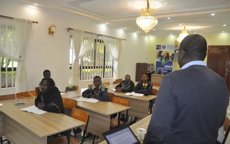 A lecturer teaching a class in a bright IDIA College lecture room